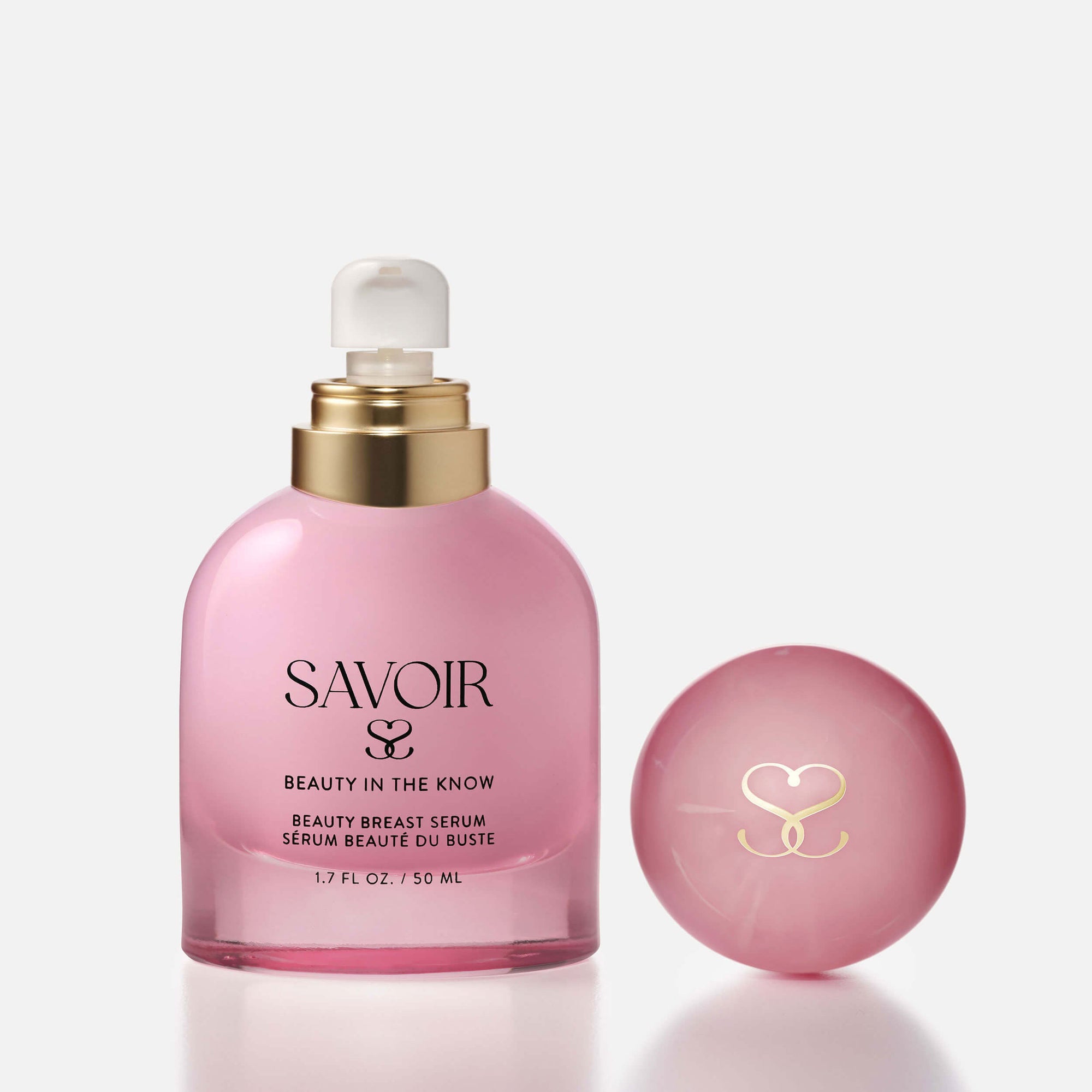 Single SAVOIR Beauty Breast Serum bottle with cap removed and placed next to it, showing the pump top and elegant branding.