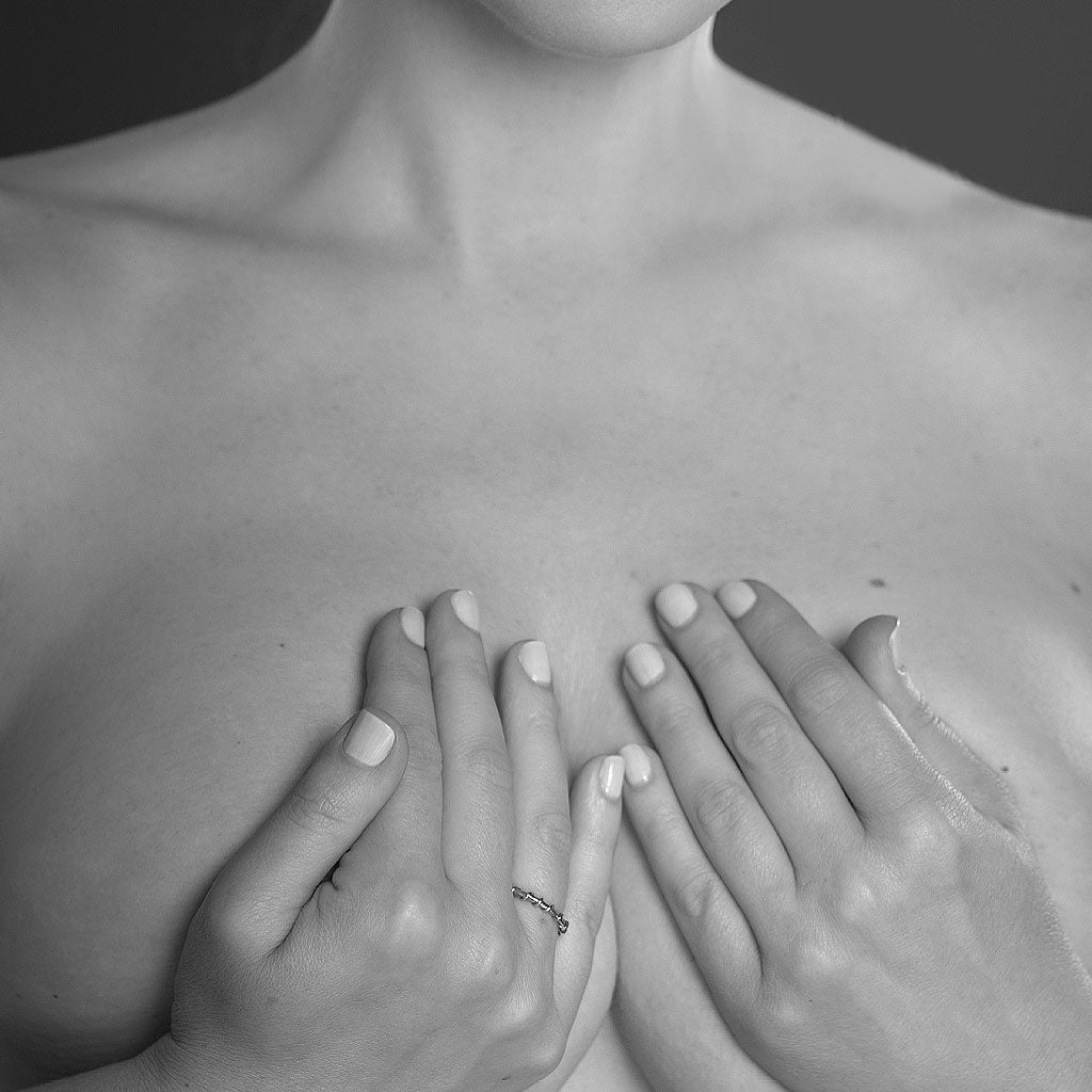 Black and white image of a woman’s torso and her hands